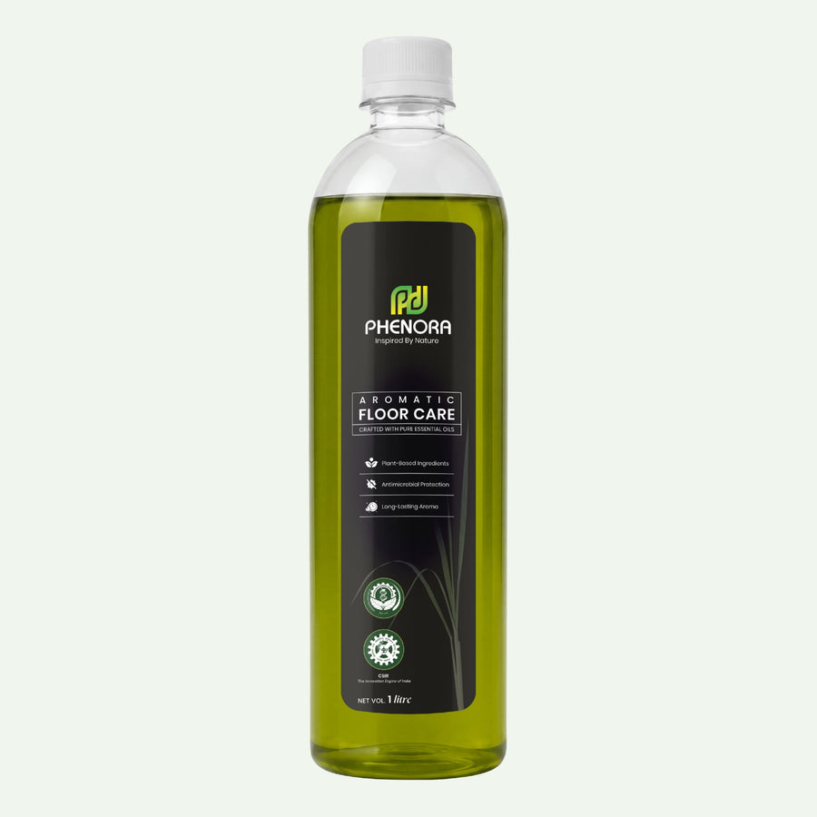 A 1L clear plastic bottle of Phenora Aromatic Floor Care liquid with a white cap, filled with yellow-green liquid, set against a solid off-white background.